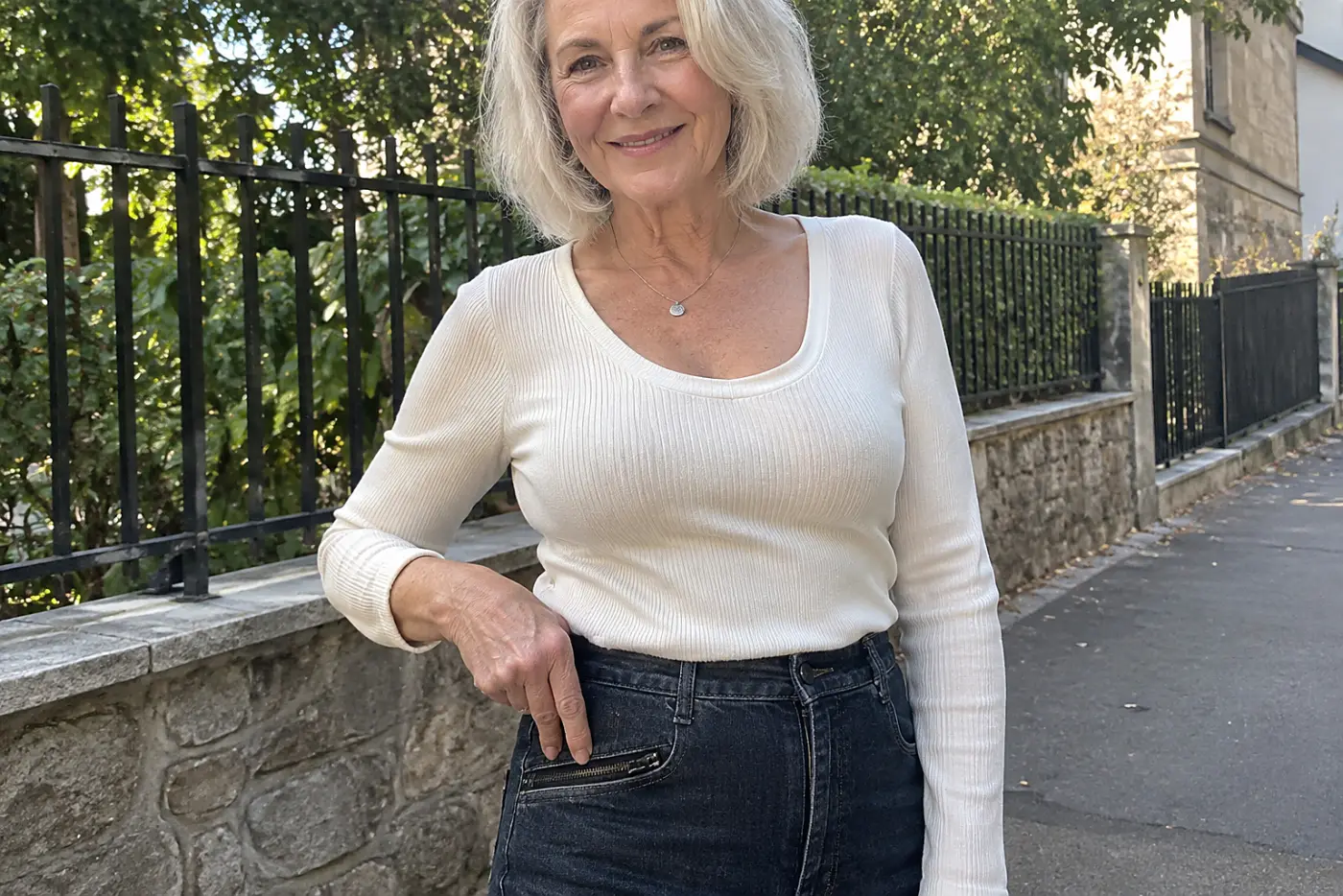Older woman checking the zippered pocket of her jeans on a town street.