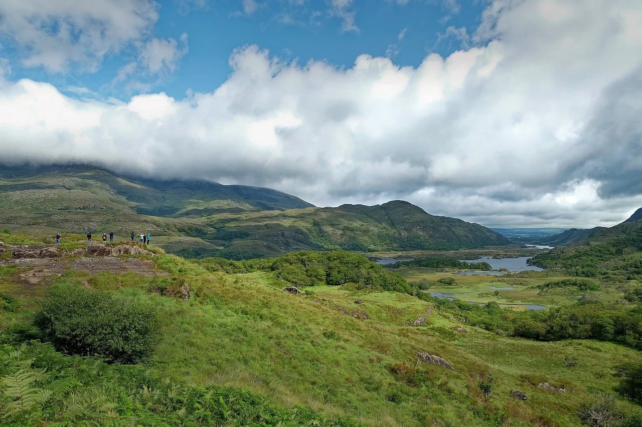 Green hills, lakes and low clouds at Ladies View on the Ring of Kerry, Ireland, with distant visitors