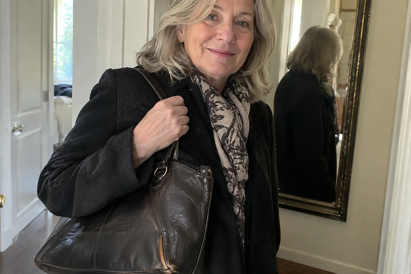 A woman in her sixties carries a dark leather handbag with fraying corners.