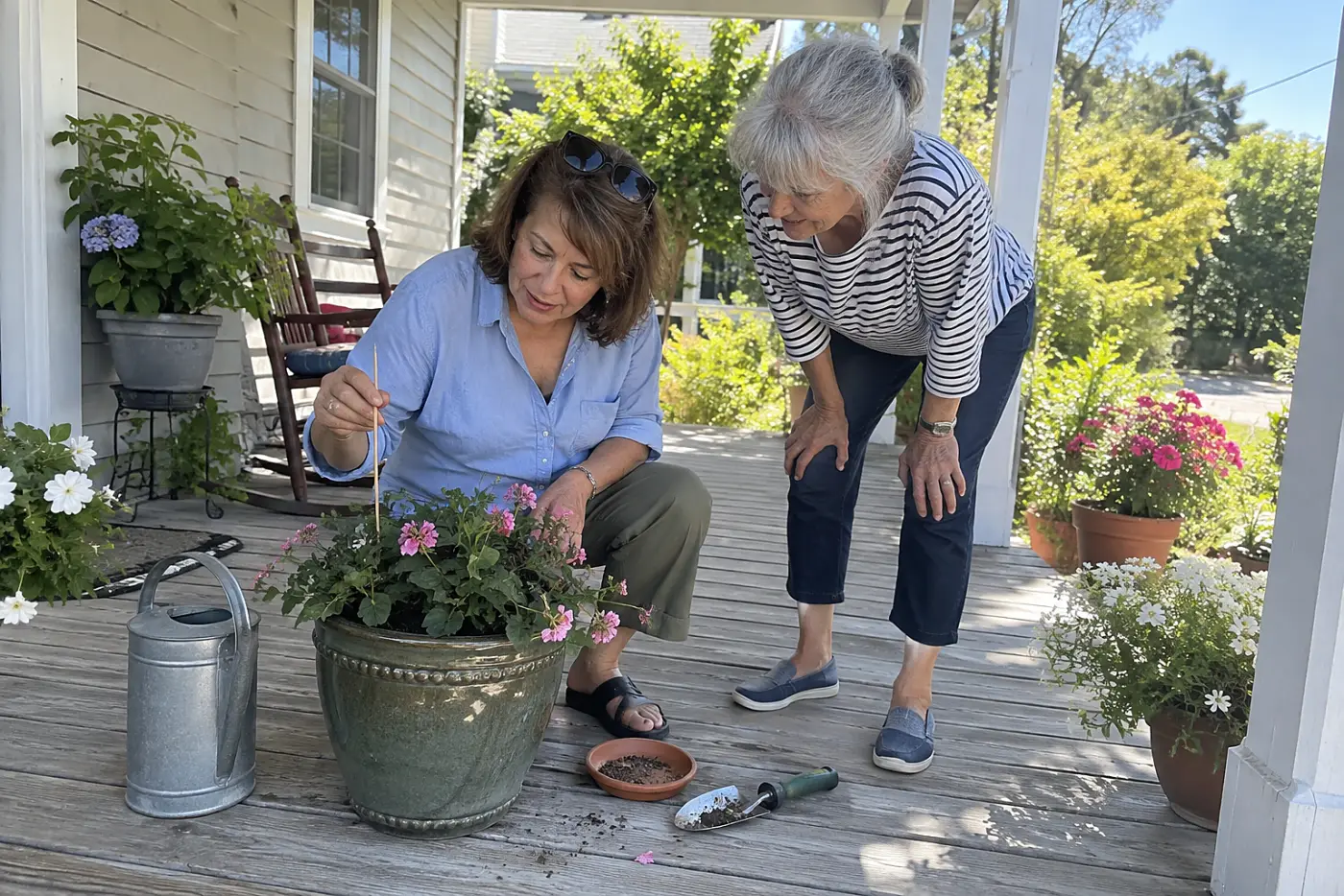 Woman pulling a wooden chopstick from a flowerpot beside her watering can.