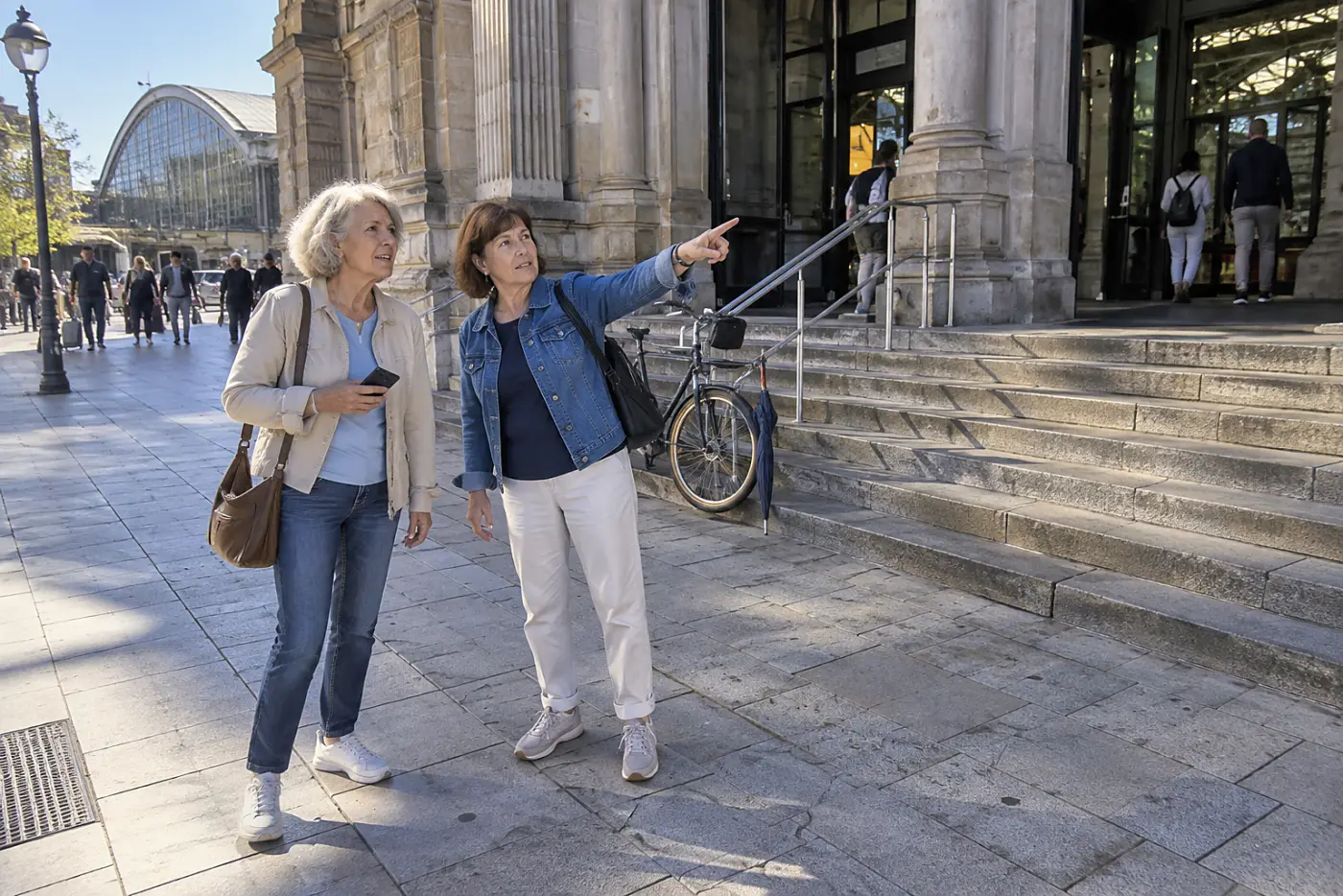 Older woman checking a walking route outside a train station.