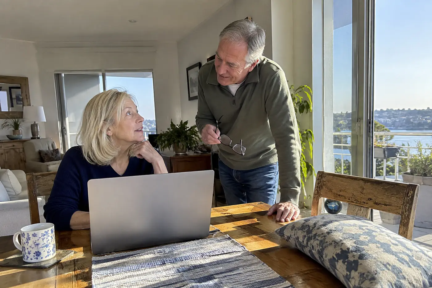 Older woman choosing a concert seat on her laptop at home.