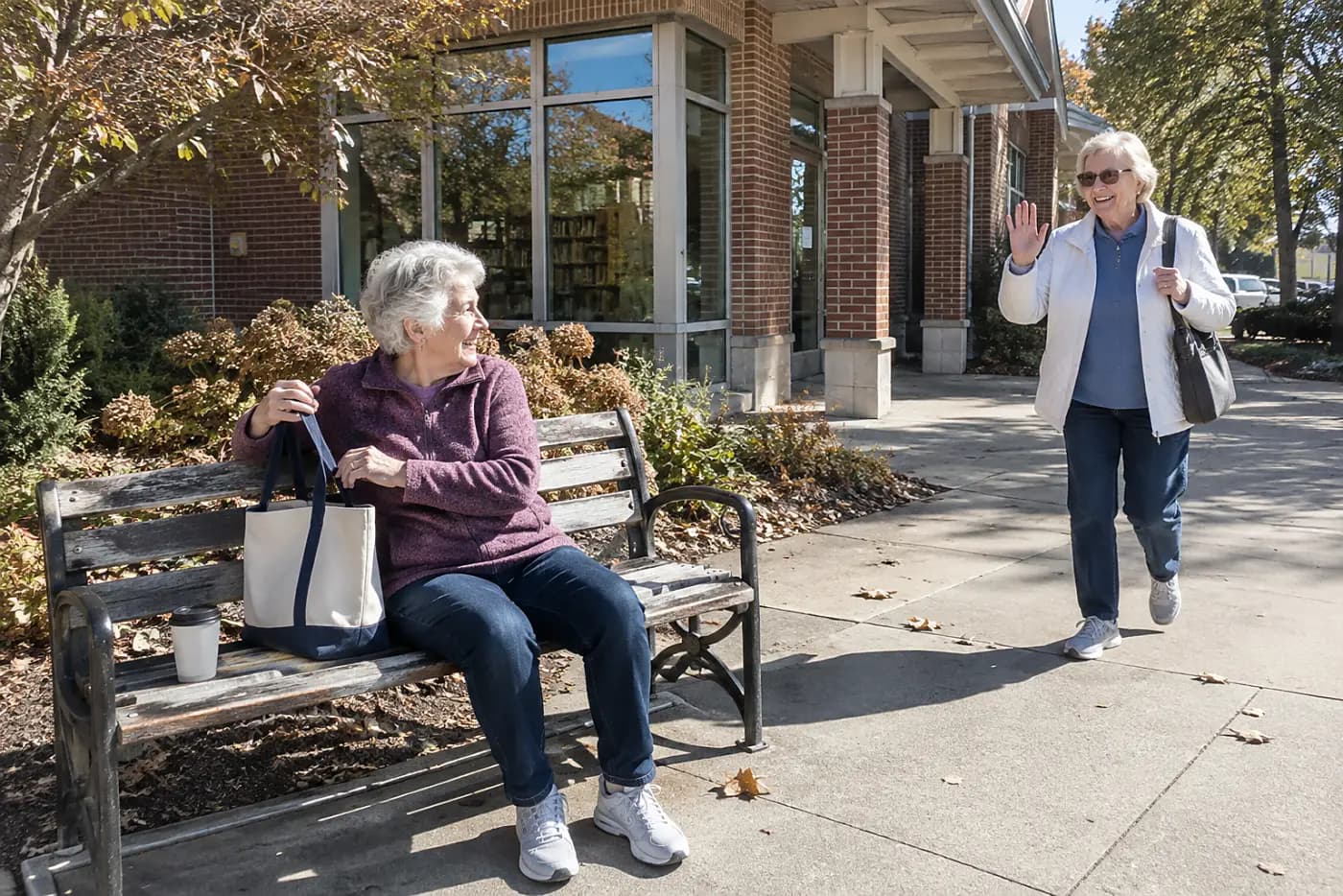 Older woman sitting on a bench outside her local library.