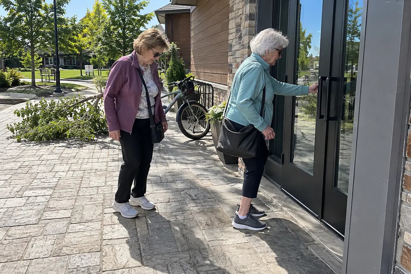 Older woman checking the entrance of a neighborhood recreation center.