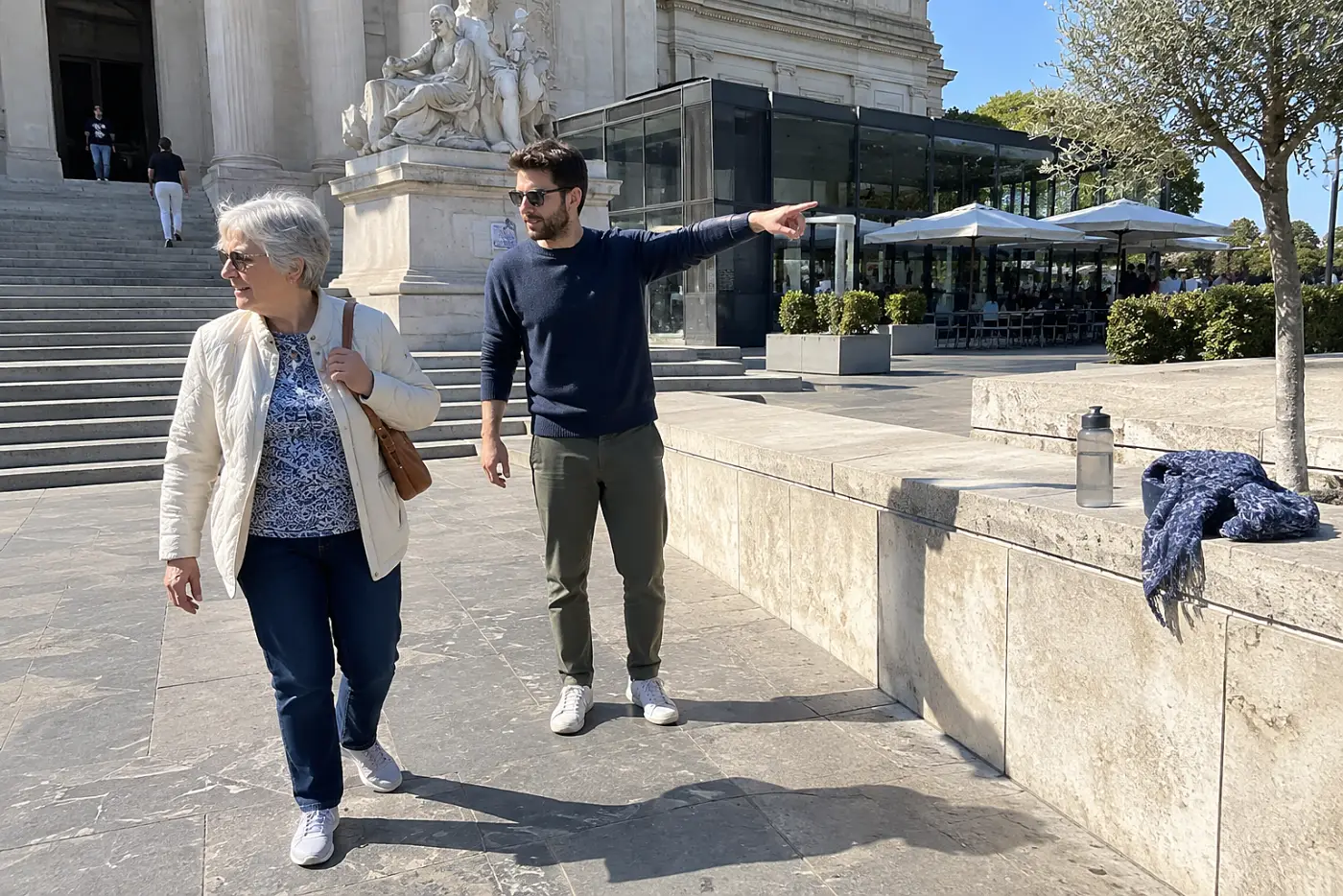 Grandmother and grandson looking at a restaurant menu outside a museum.