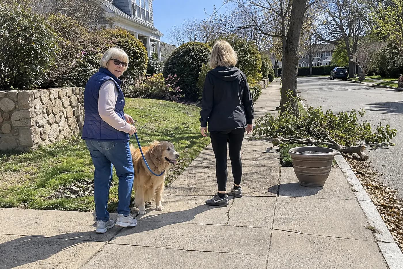 Older woman pausing during a walk on her neighborhood sidewalk.