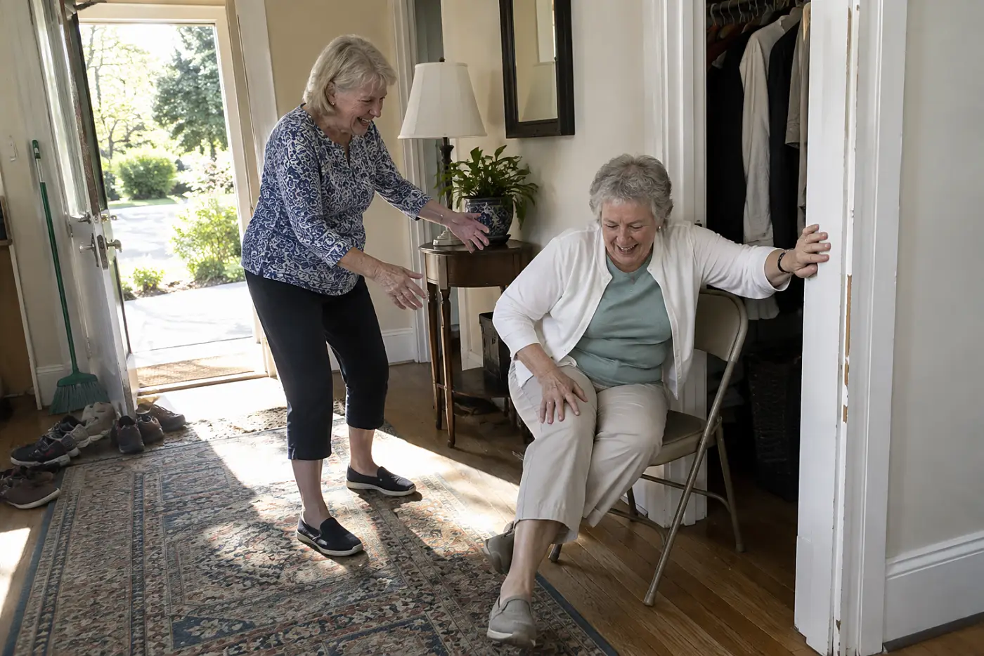 Older woman testing a folding chair beside her hall closet.