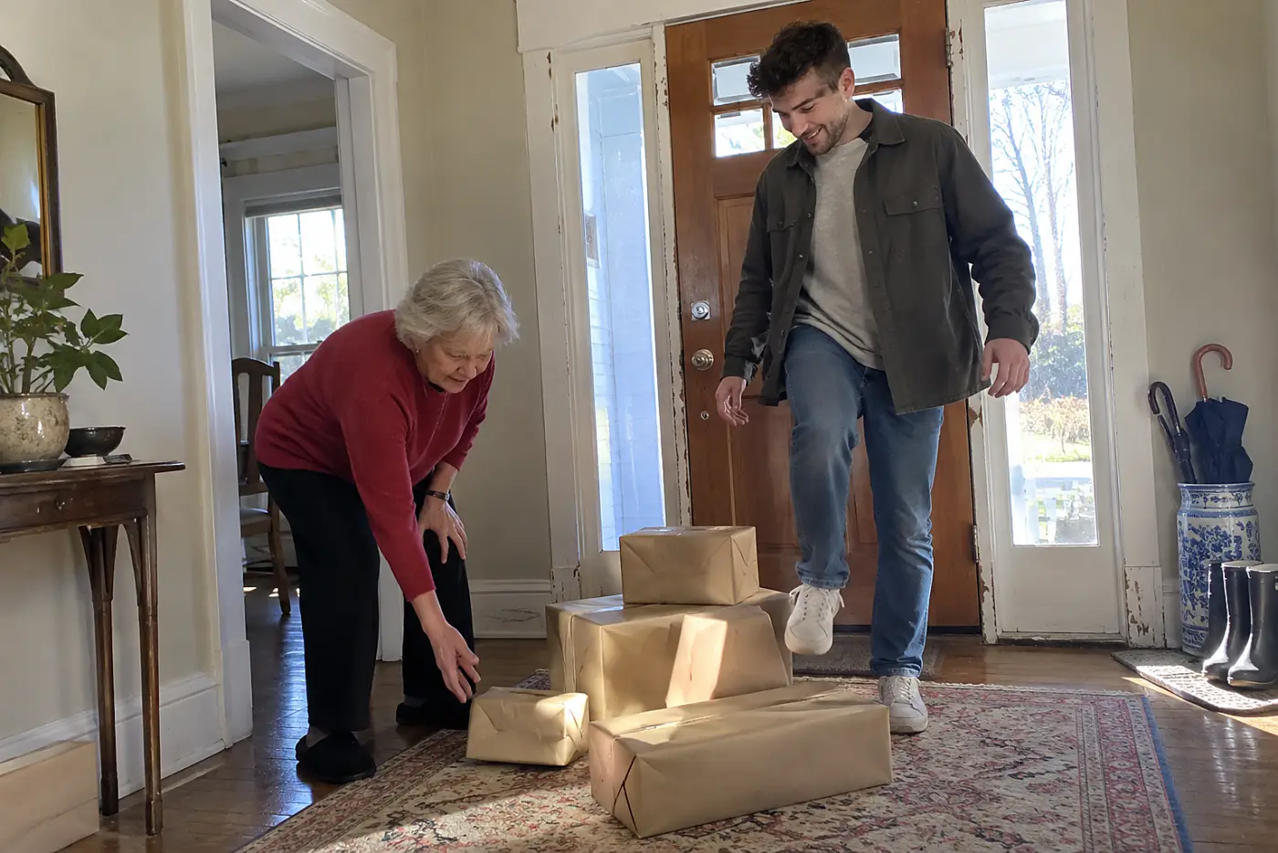 Older woman sorting wrapped gifts by her front door.