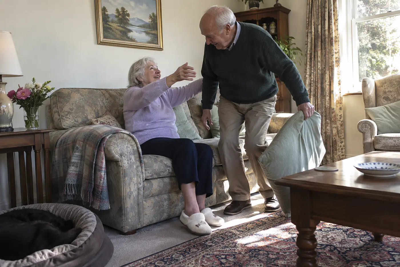 Older woman asking her husband for a hug on their living room sofa.