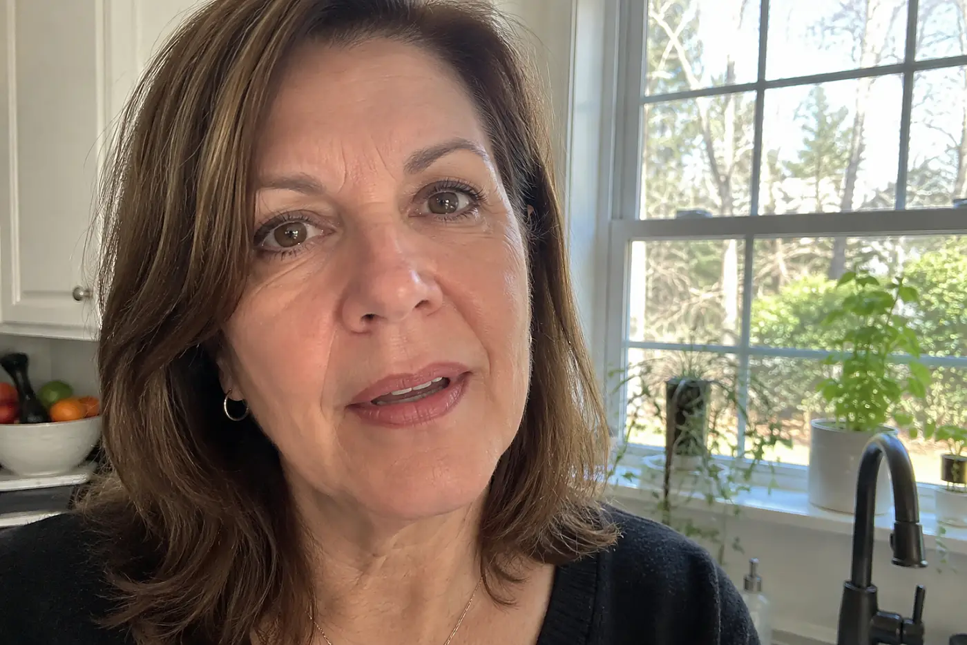 A dark lip pencil border around faded lipstick is centered on a woman in her fifties after lunch at home, with no writing visible.