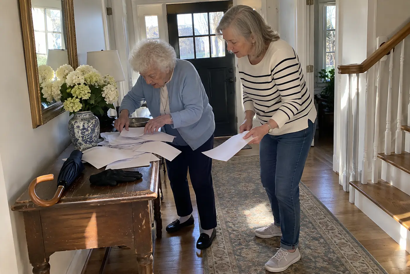 A mother searches for her car keys beneath papers on the hall table.