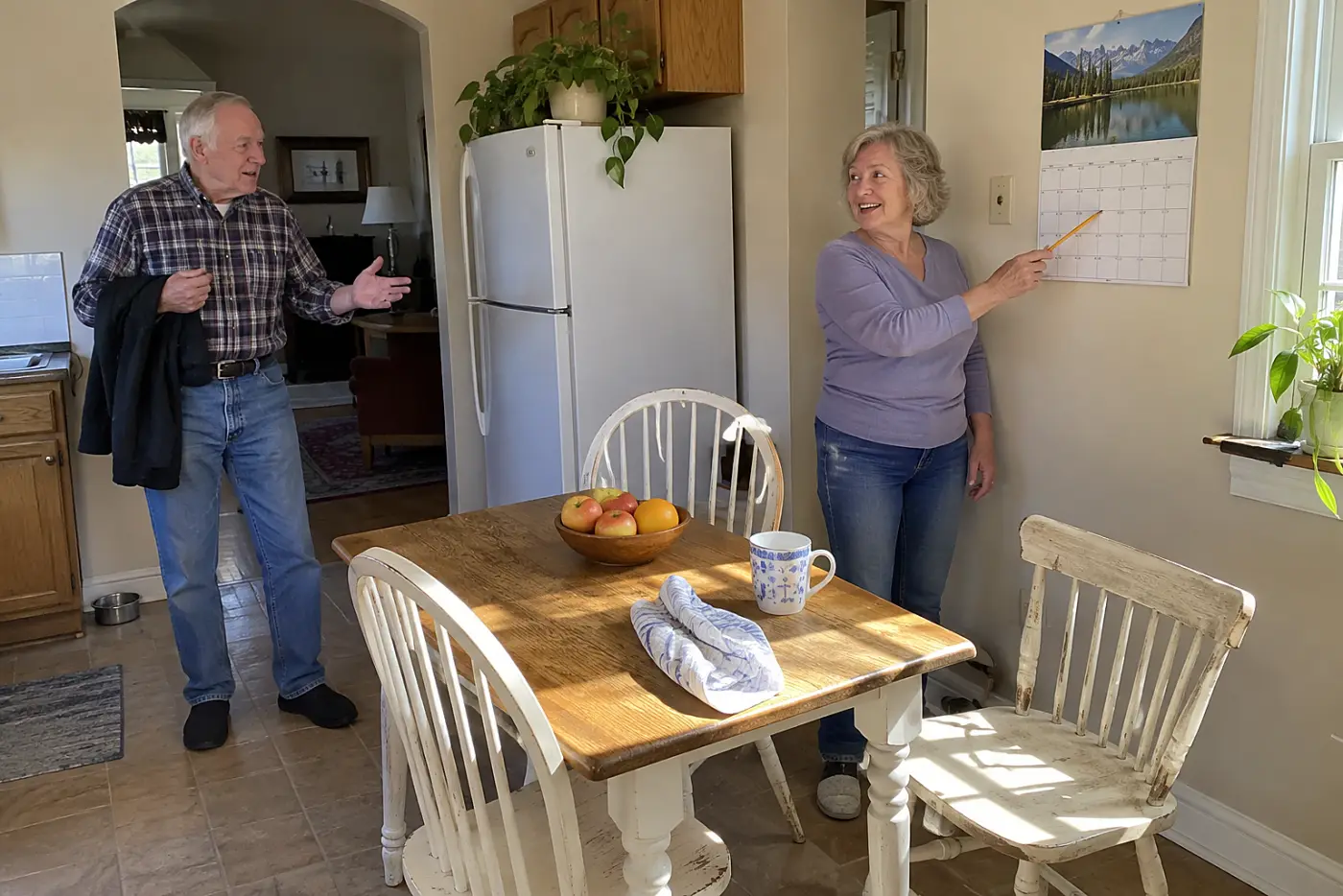 Older woman checking part-time work hours on a kitchen calendar.