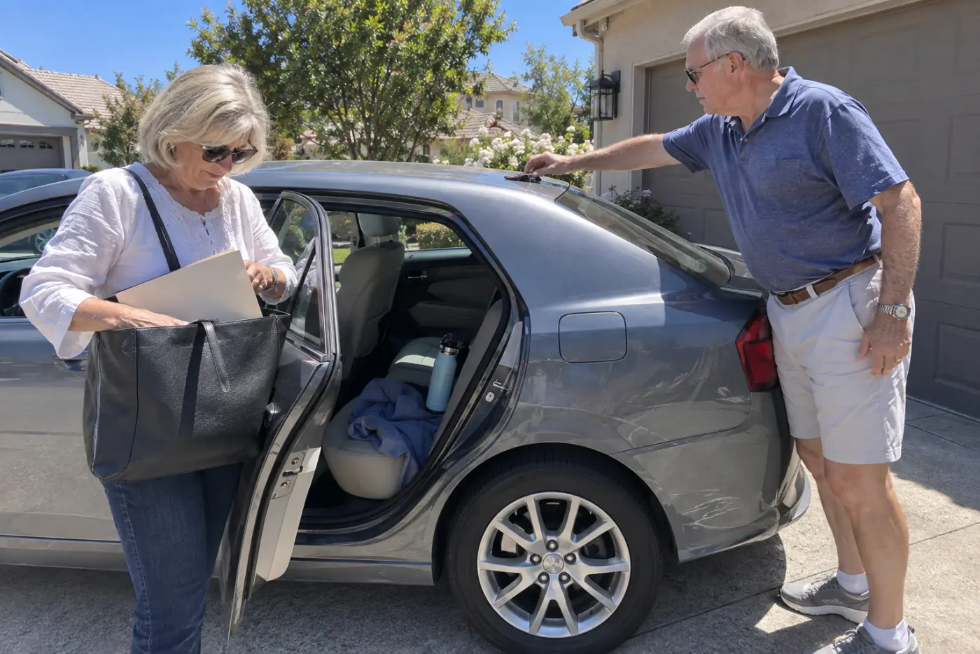 Older woman placing a folder of closing papers into a bag beside her car keys.