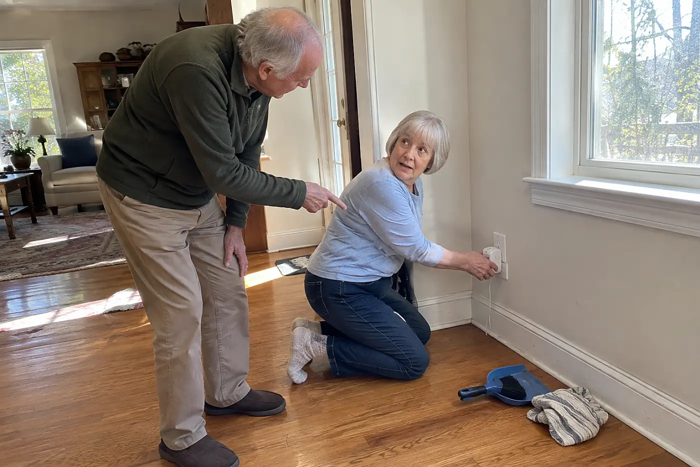 Older woman checking the plug fit on an outlet extender at home.