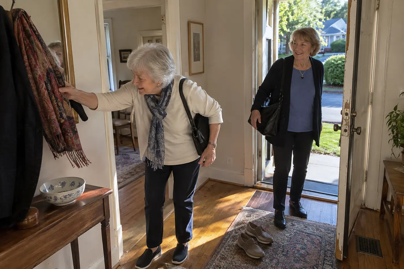 Woman walking her friend to the door after dinner at home.