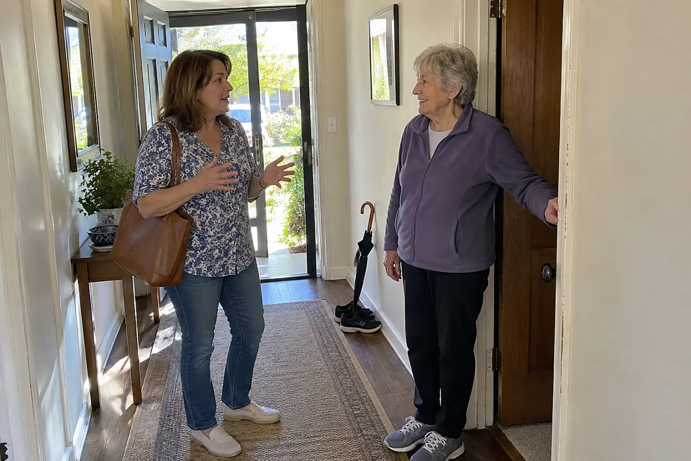 Woman taking a breath while talking with someone in a hallway.