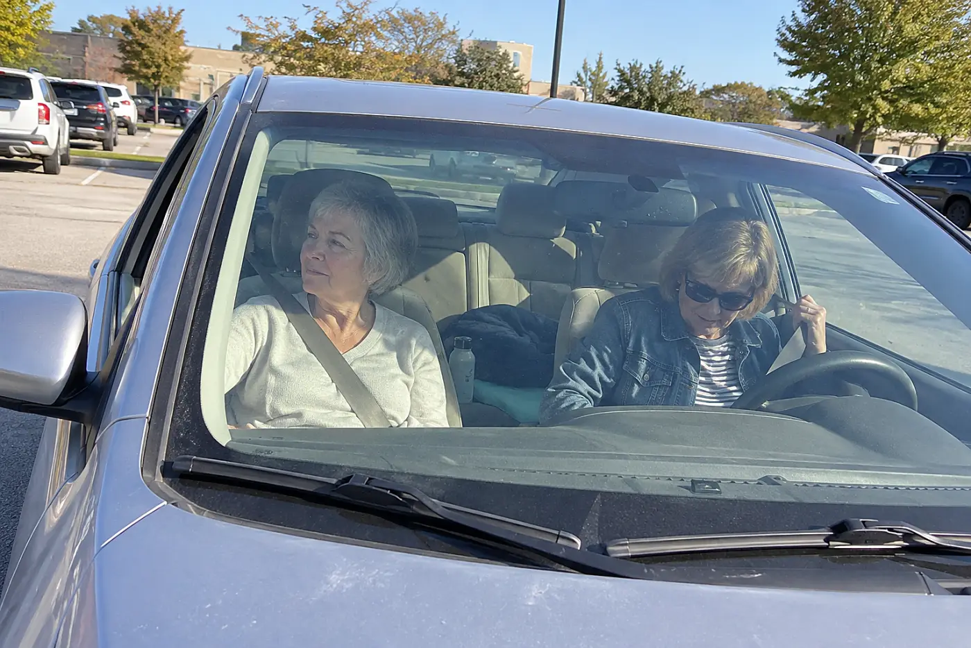 Older woman looking out a car window after a medical appointment.