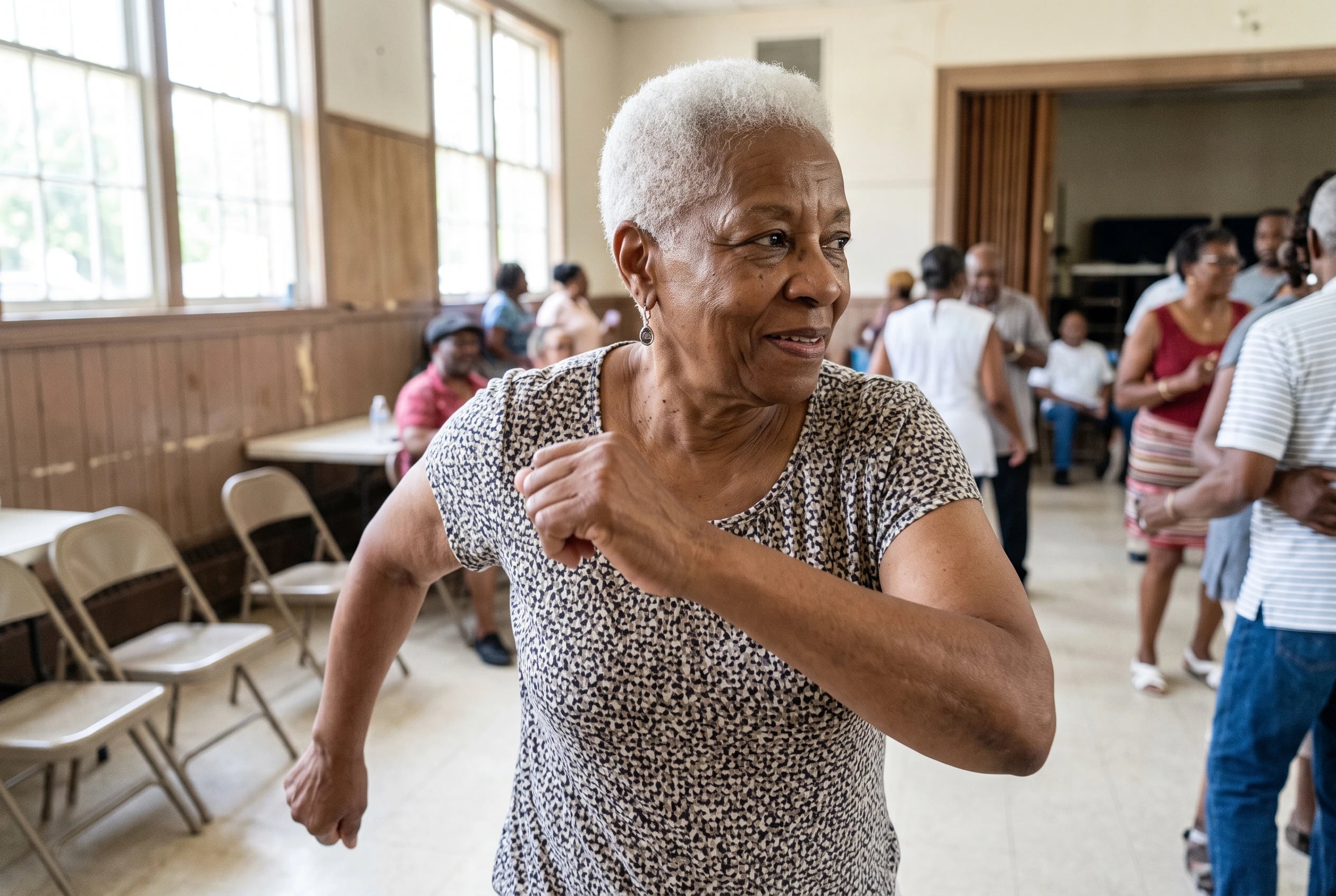 Older woman moving her arms through the Jerk at a neighborhood dance.