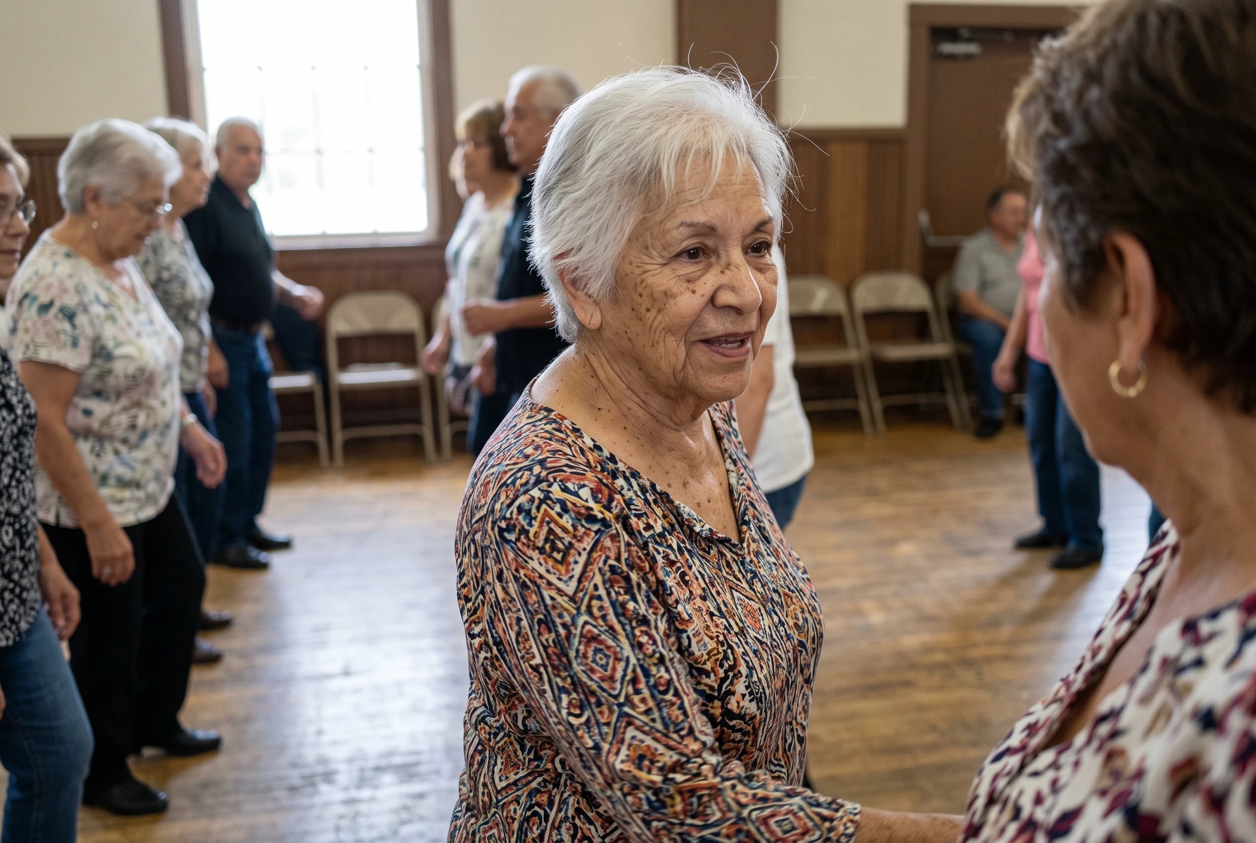 Older woman side-stepping in one of two facing lines at a community hall dance.